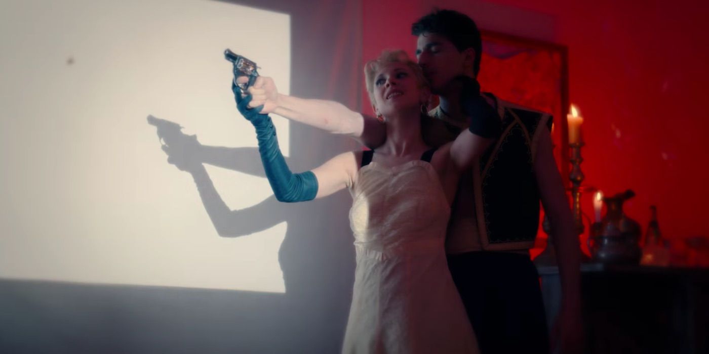 Lucy holds a gun while embracing a man in Little Birds