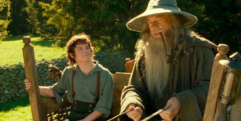 Frodo and Gandalf sitting on a bench in Lord of the Rings: The Fellowship of the Ring.