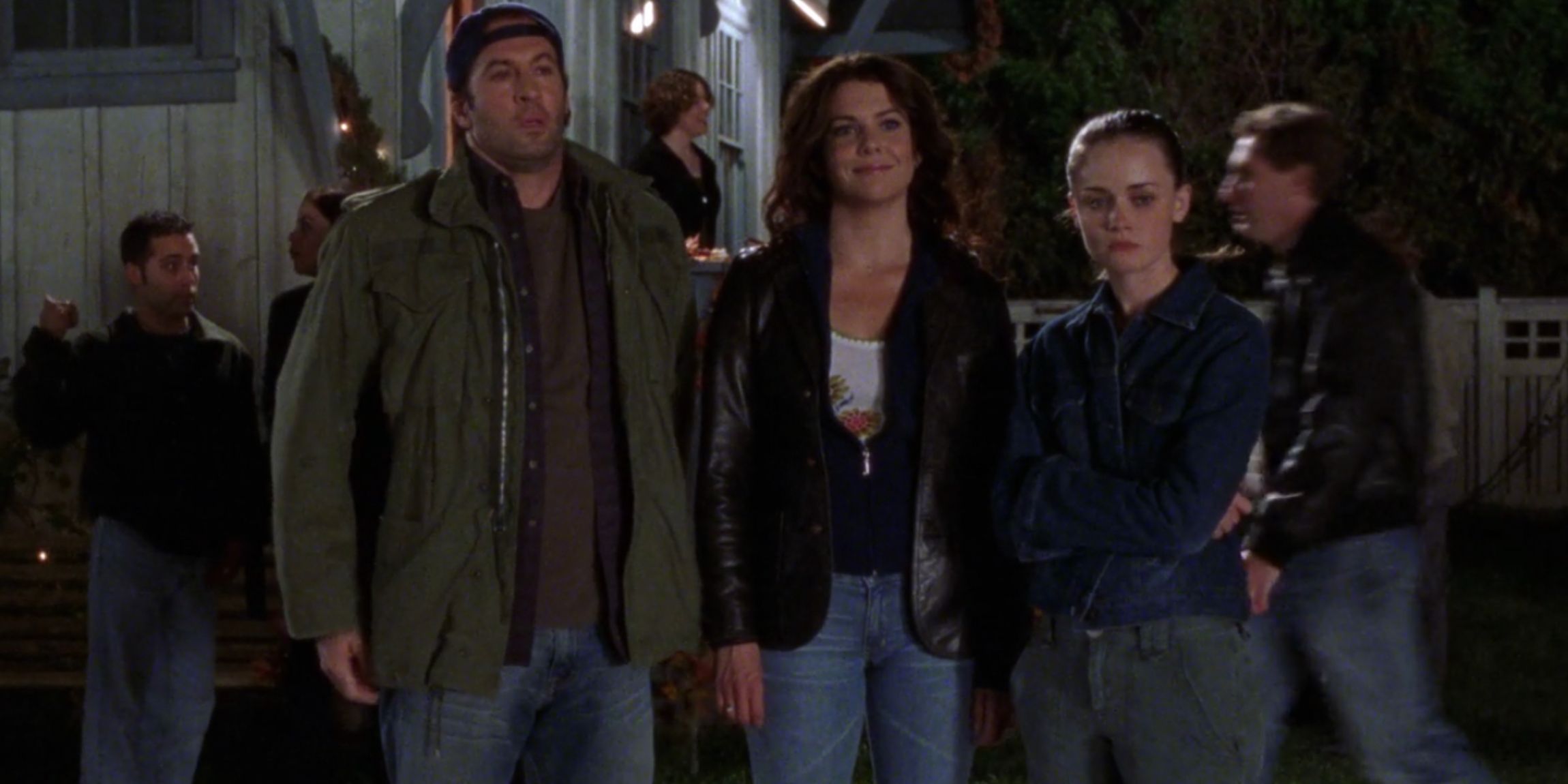 Luke, Lorelai, and Rory outside of a town hall meeting in Gilmore Girls