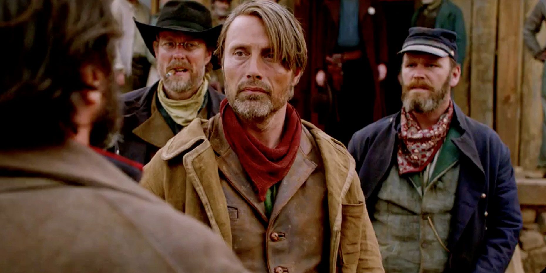 Mads Mikkelsen surrounded by bad guys in The Salvation