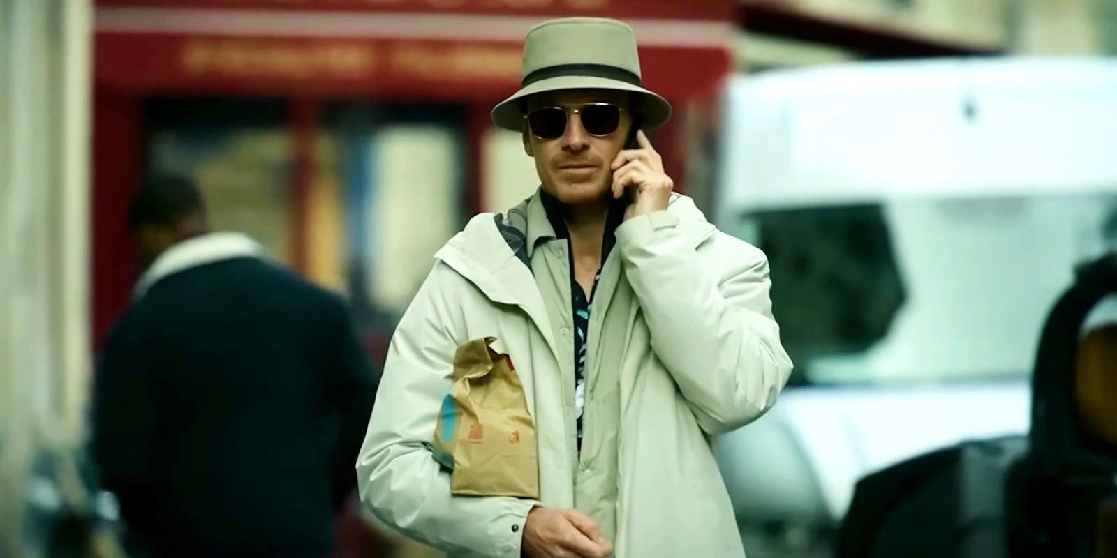 Michael Fassbender talking on the phone in The Killer