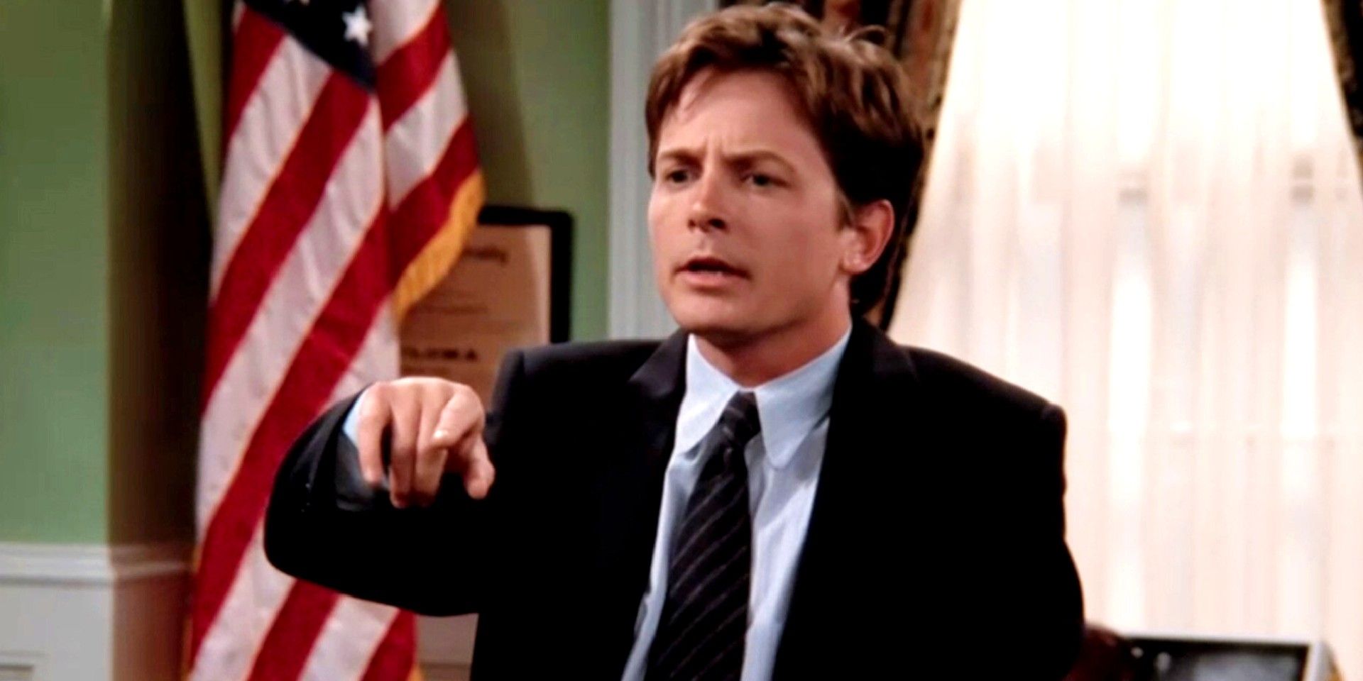 Michael J Fox pointing at something in Spin City