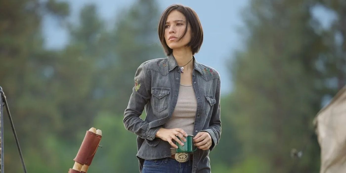 Monica Dutton (Kelsey Asbille) standing with a cup in Yellowstone