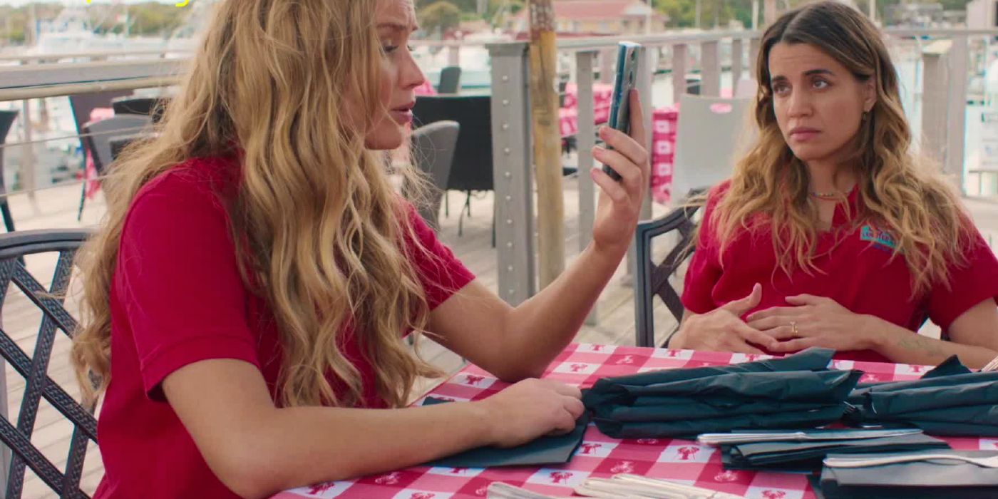 Maddie talks on the phone next to Sara on the dock.