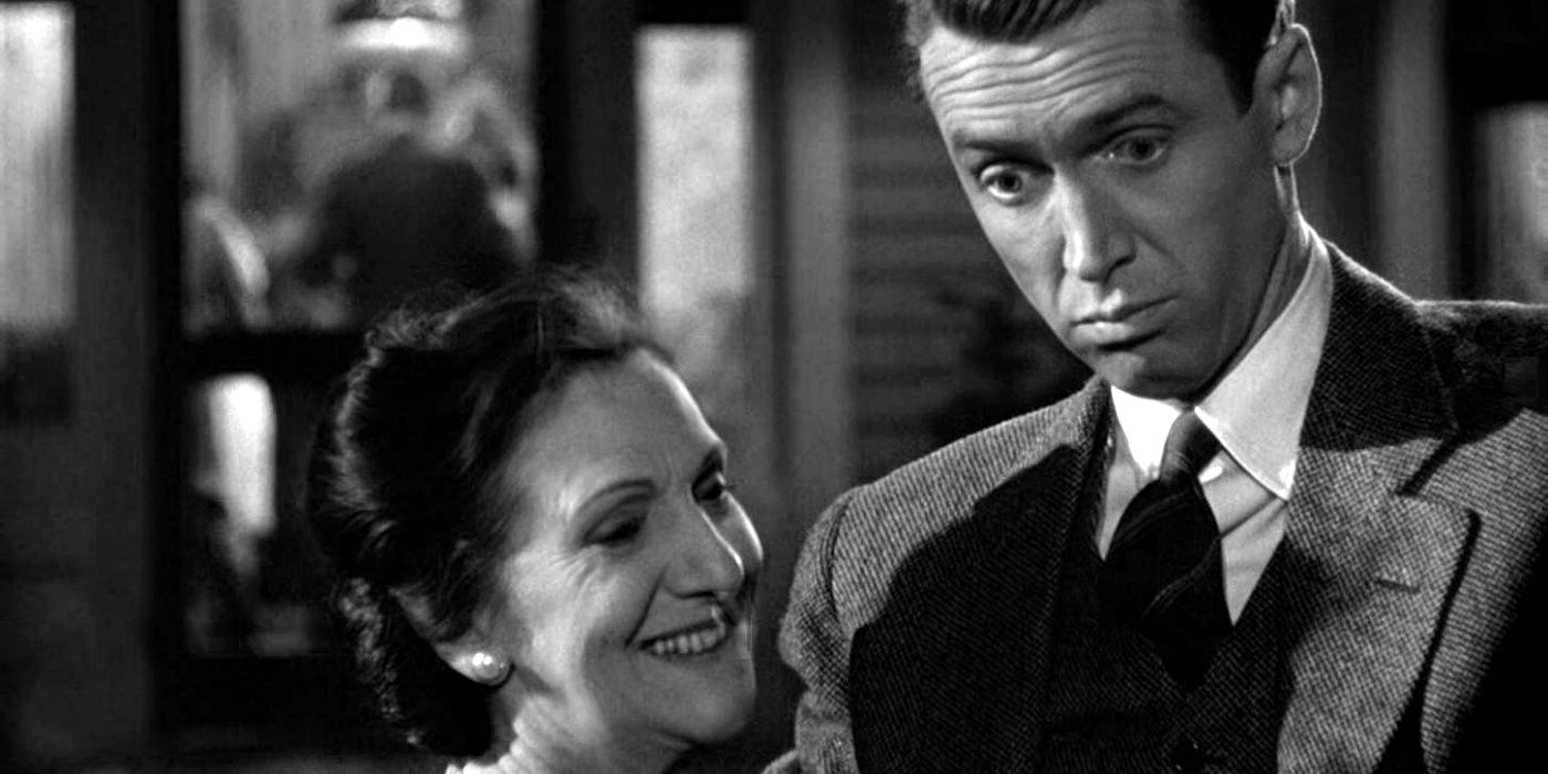 Beulah Bondi as Mrs. Bailey smiling and James Stewart as George Bailey looking surprised in It's a Wonderful Life.