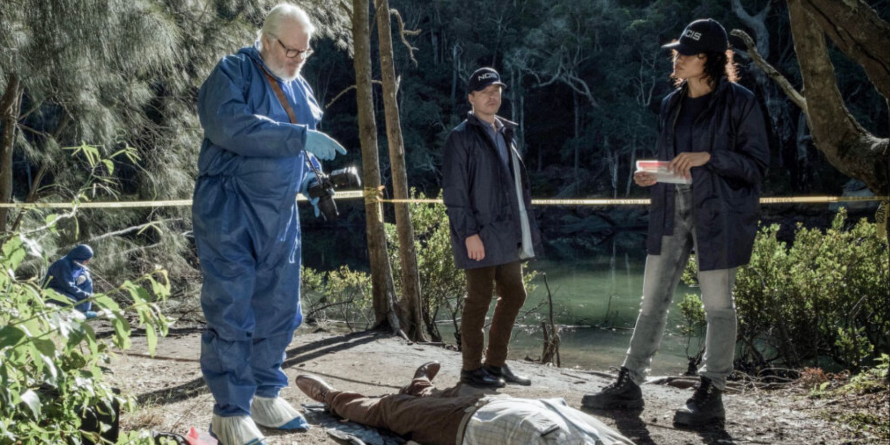 NCIS Sydney investigators with the medical examiner over a dead body