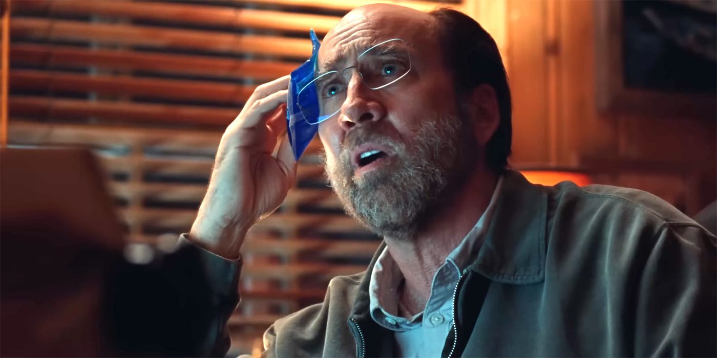 Nicolas Cage holds an icepack to his head in Dream Scenario
