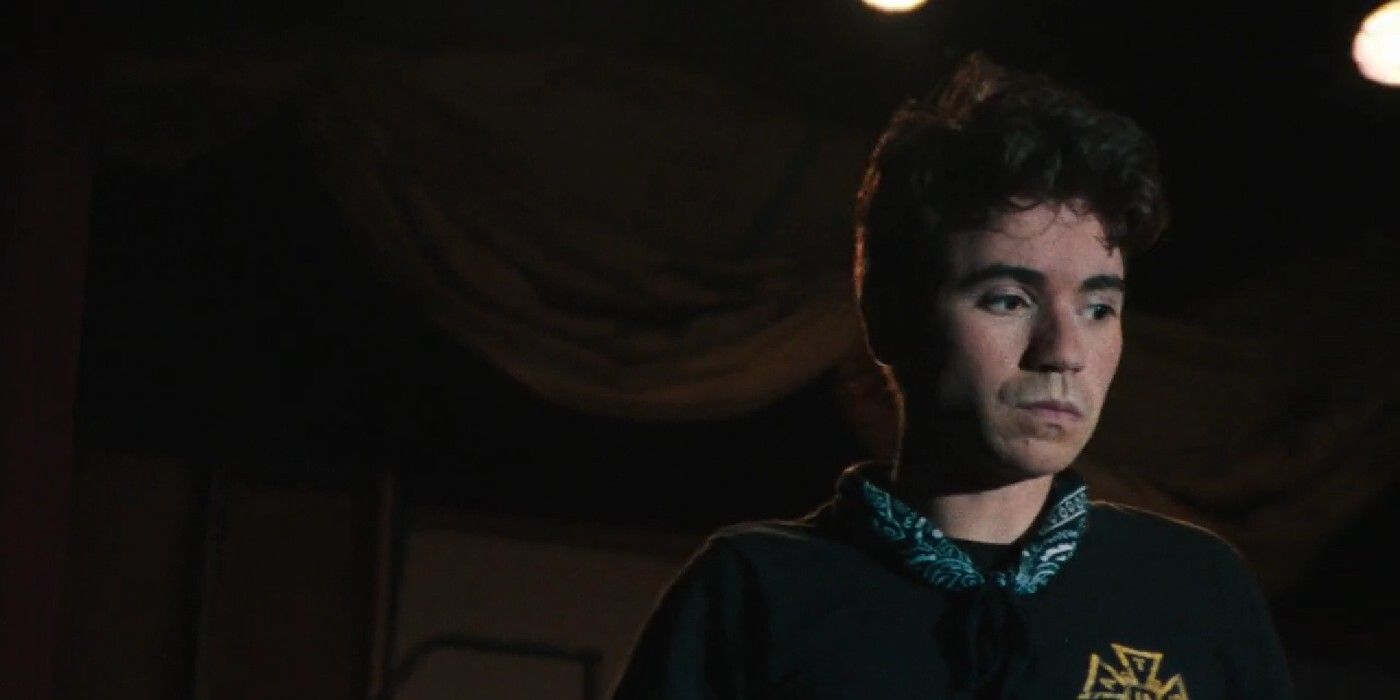 A screencap of Noah Galvin as Glenn in Theater Camp as he looks to the side.