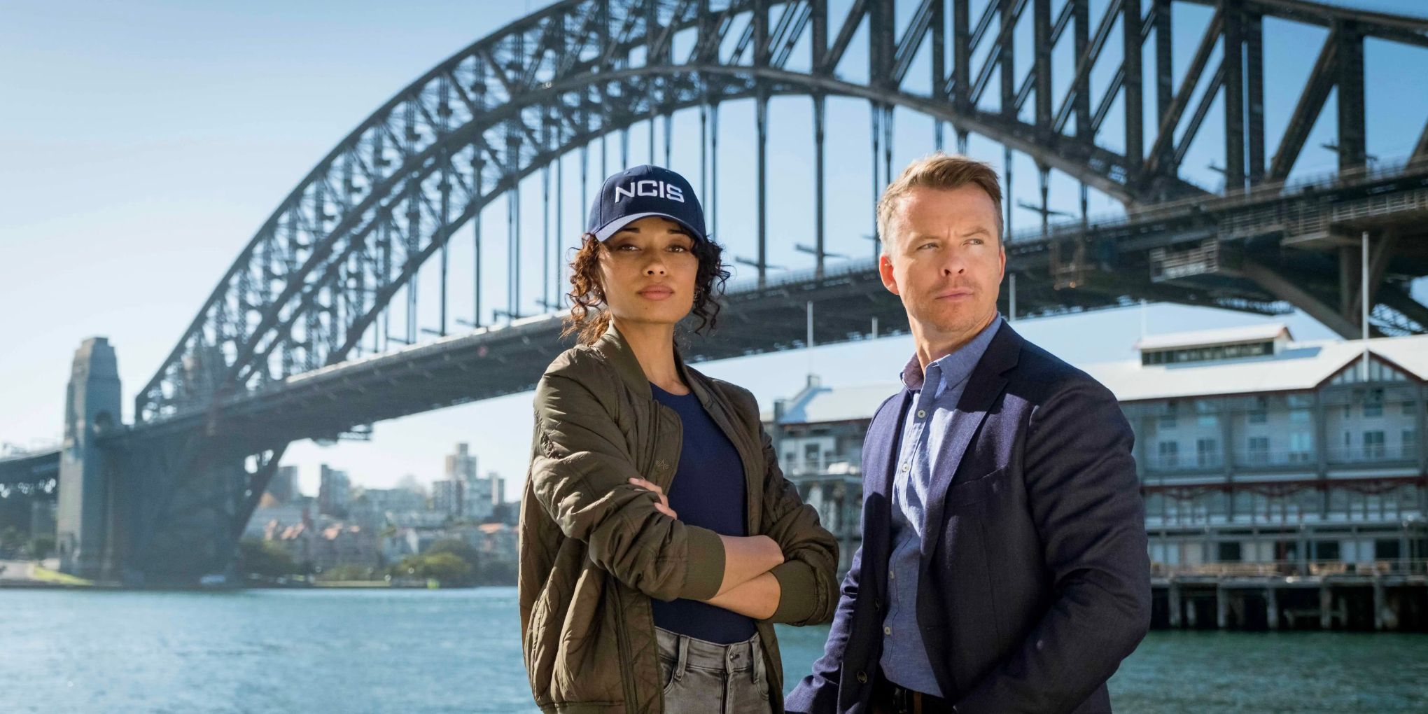 Olivia Swann and Todd Lasance in front of a bridge in NCIS Sydney
