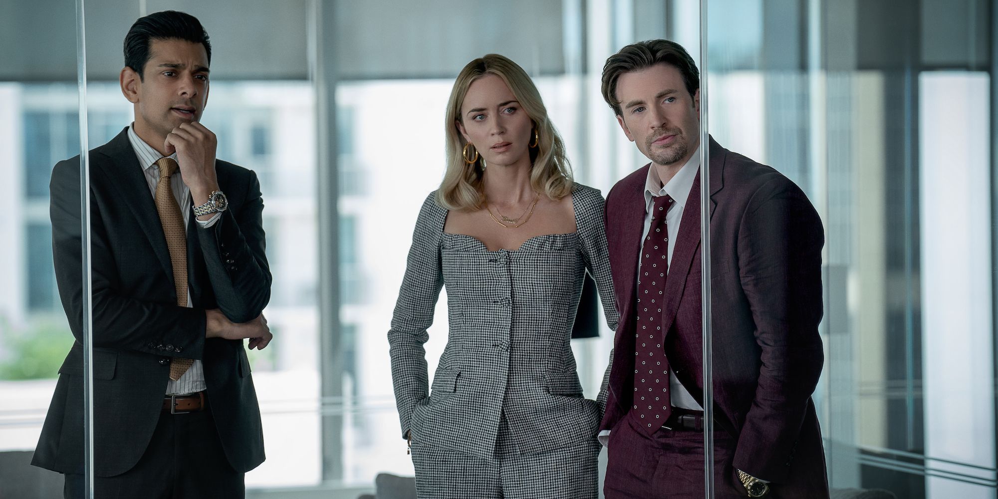 Amit Shah, Emily Blunt and Chris Evans in an office at Pain Hustlers