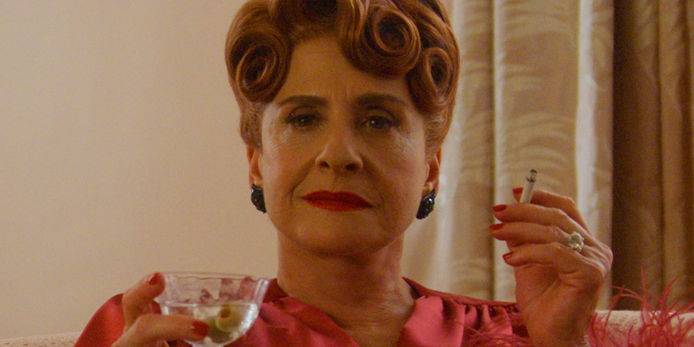 Patti LuPone as Avis Amberg in Hollywood holding a drink and a cigarette