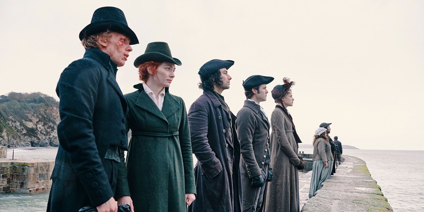 Ross and Demelza look at the ocean alongside several others in Poldark