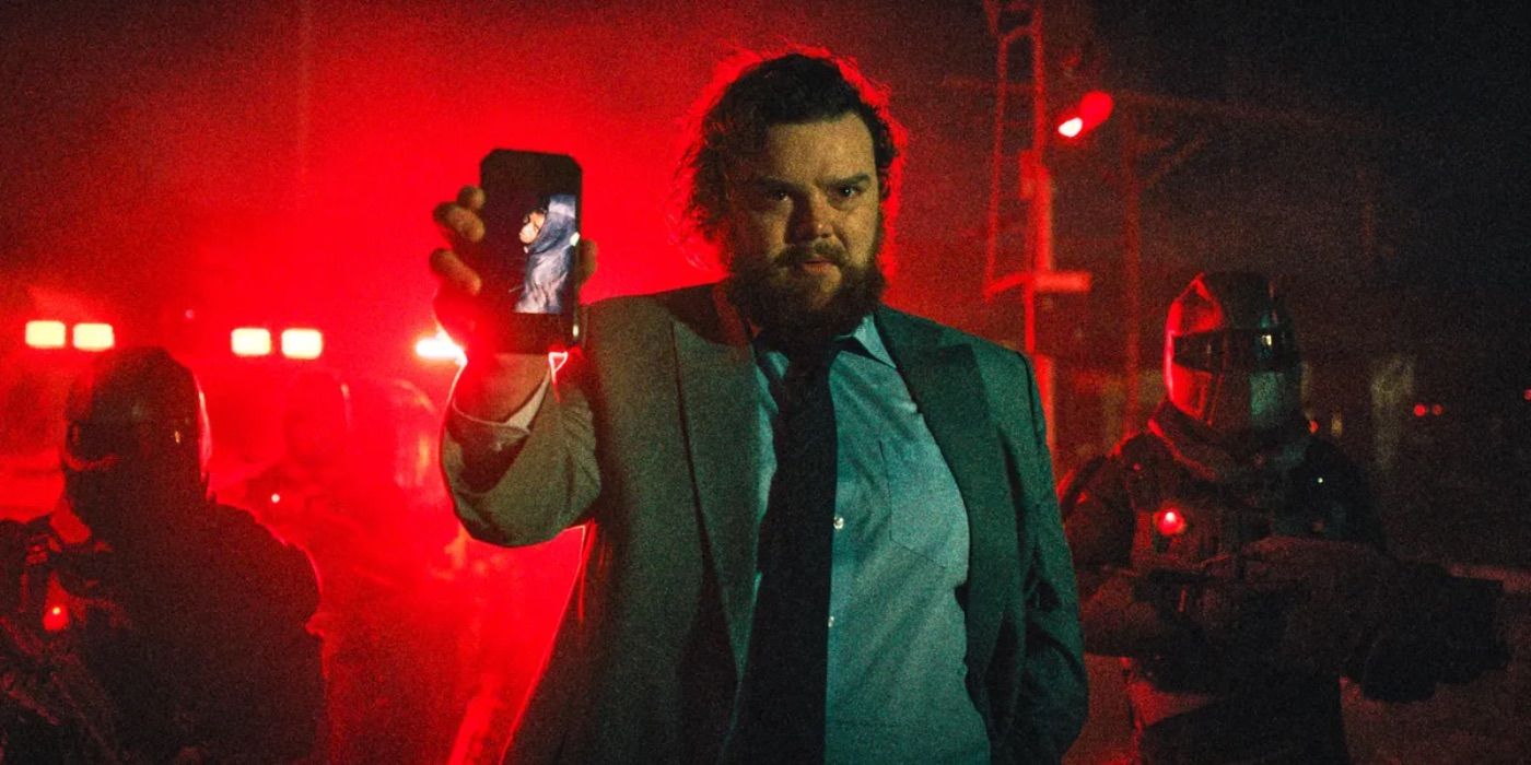 a man holds a phone in Resident Evil 