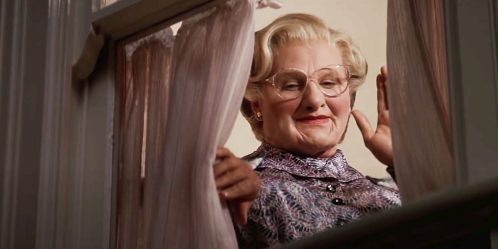 Robin Williams as Mrs. Doubtfire waving from a window