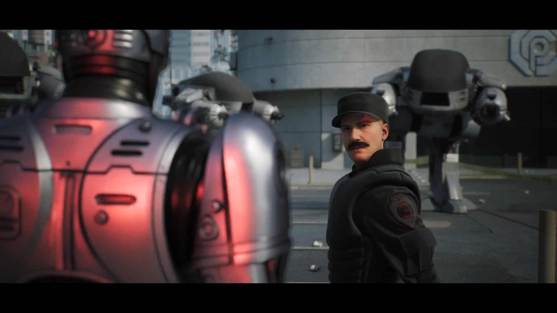 Screenshot from RoboCop Rogue City cutscene shows a moustached SWAT team member looking at RoboCop with disbelieve while three large ED 209 robots stand behind him in front of a bank.