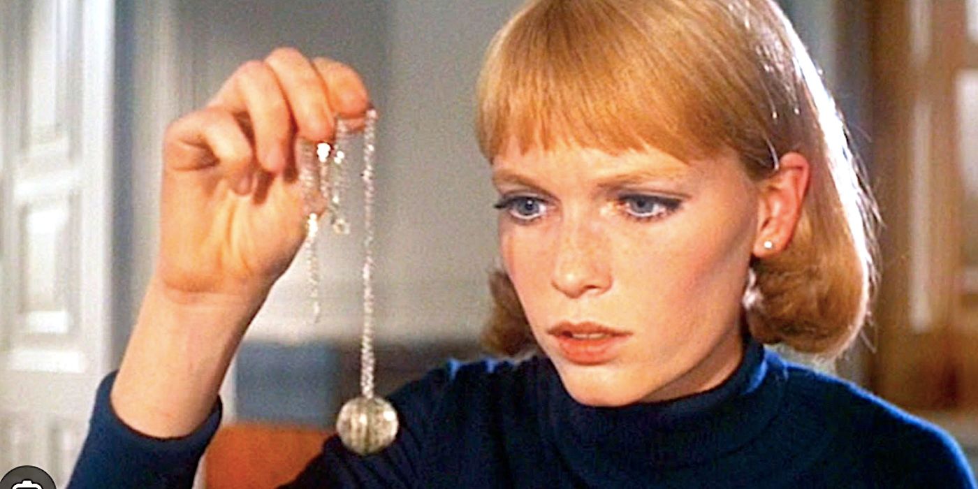 Rosemary surveys the small silver Tannis Root talisman in Rosemary's Baby