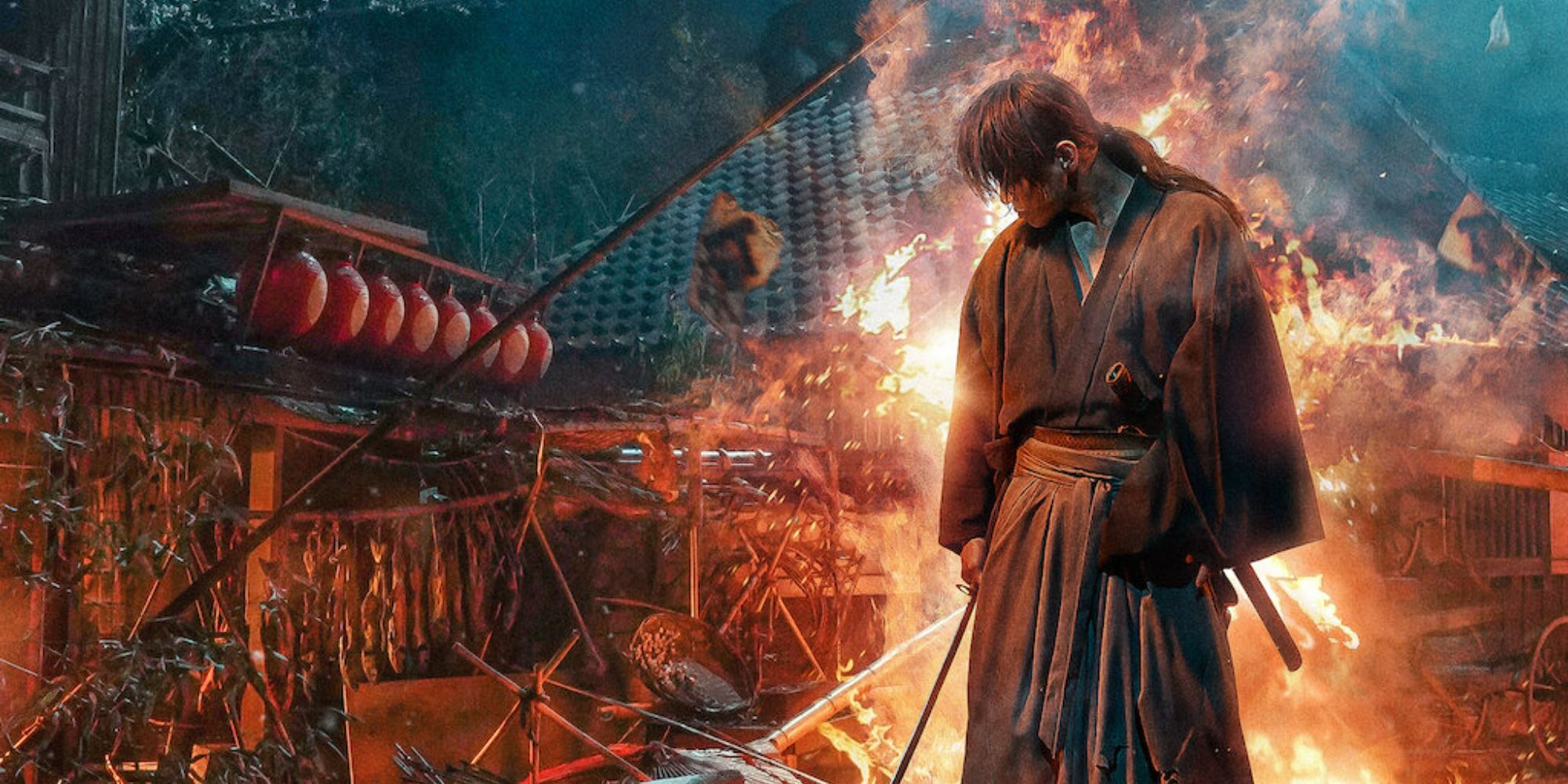 A warrior stands in front of fire and damaged houses in Rurouni Kenshin Final Chapter Part I - The Final