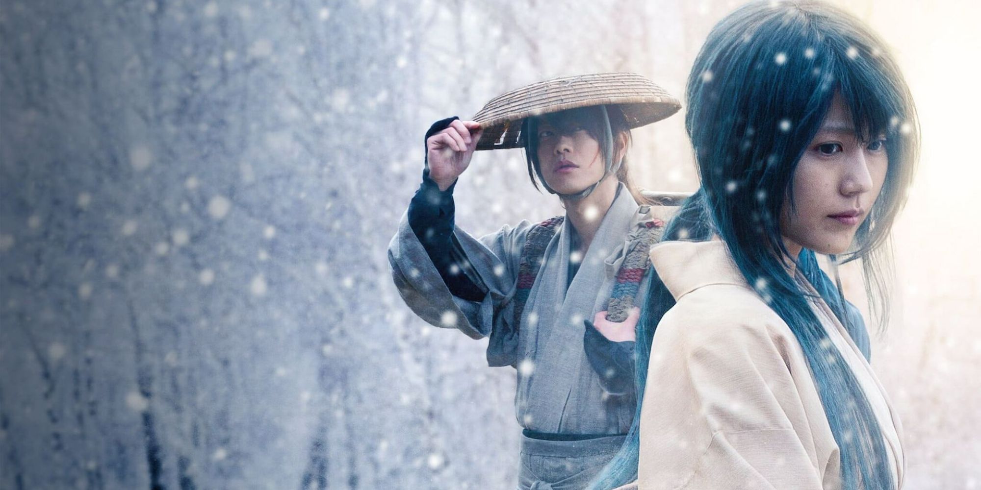 A man and woman stand in falling snow in Rurouni Kenshin Final Chapter Part II - The Beginning
