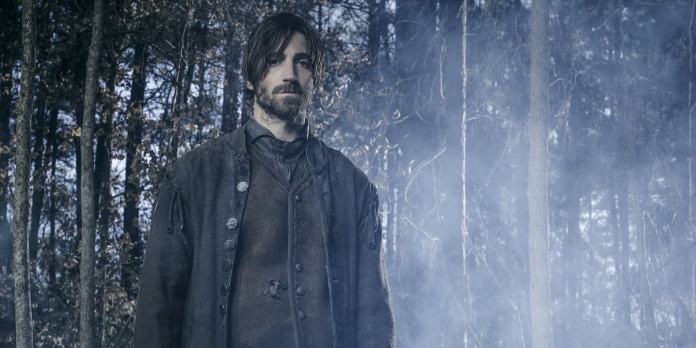 Isaac stands in the woods in Salem