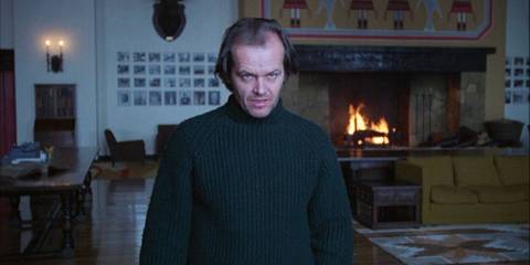 Jack Nicholson's Jack Torrance stares out a window in The Shining