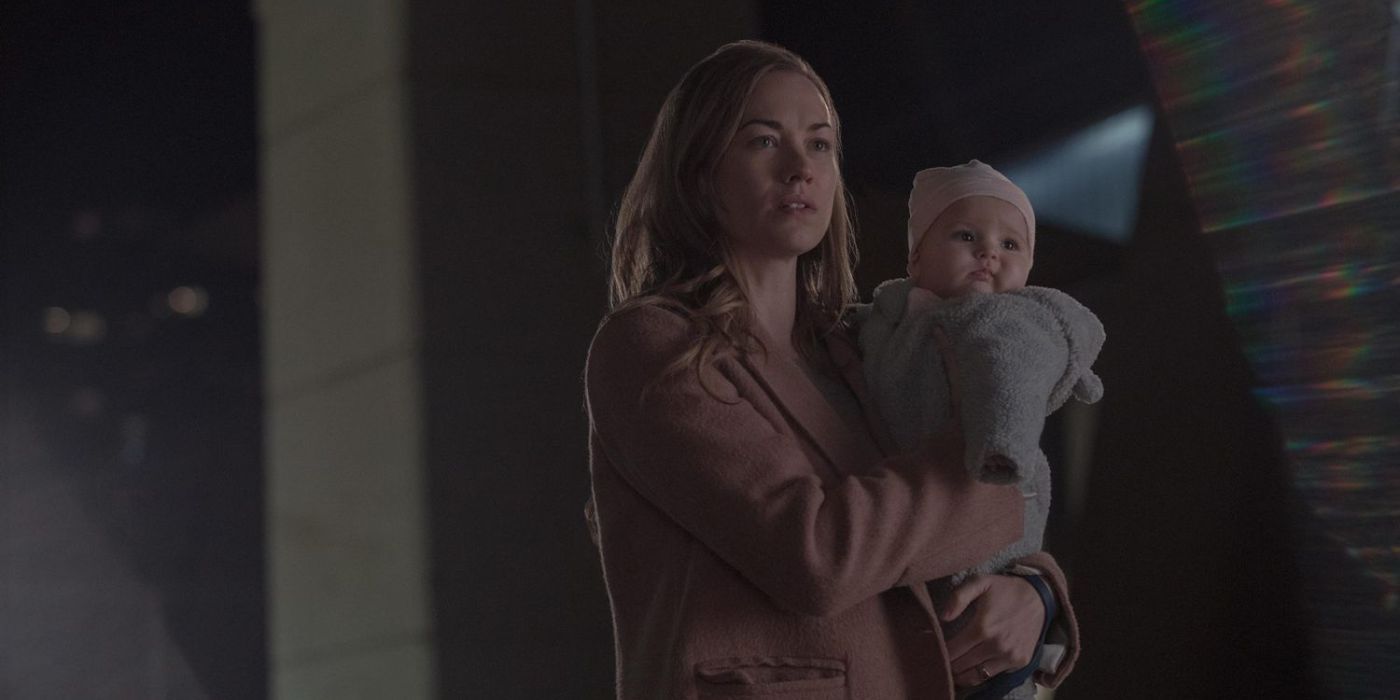 Serena holding her baby as they prepare to run away in The Handmaid’s Tale.