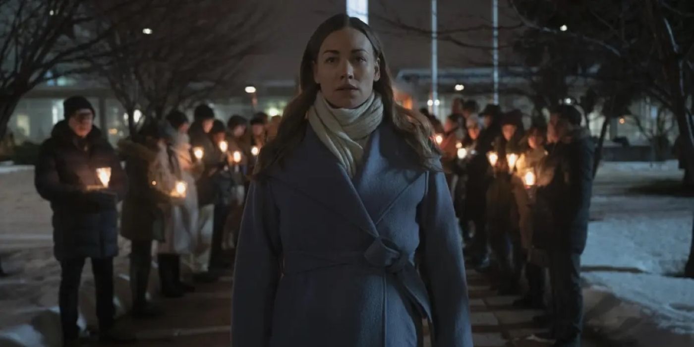 Serena walking past light-bearing acolytes in Canada in The Handmaid’s Tale.
