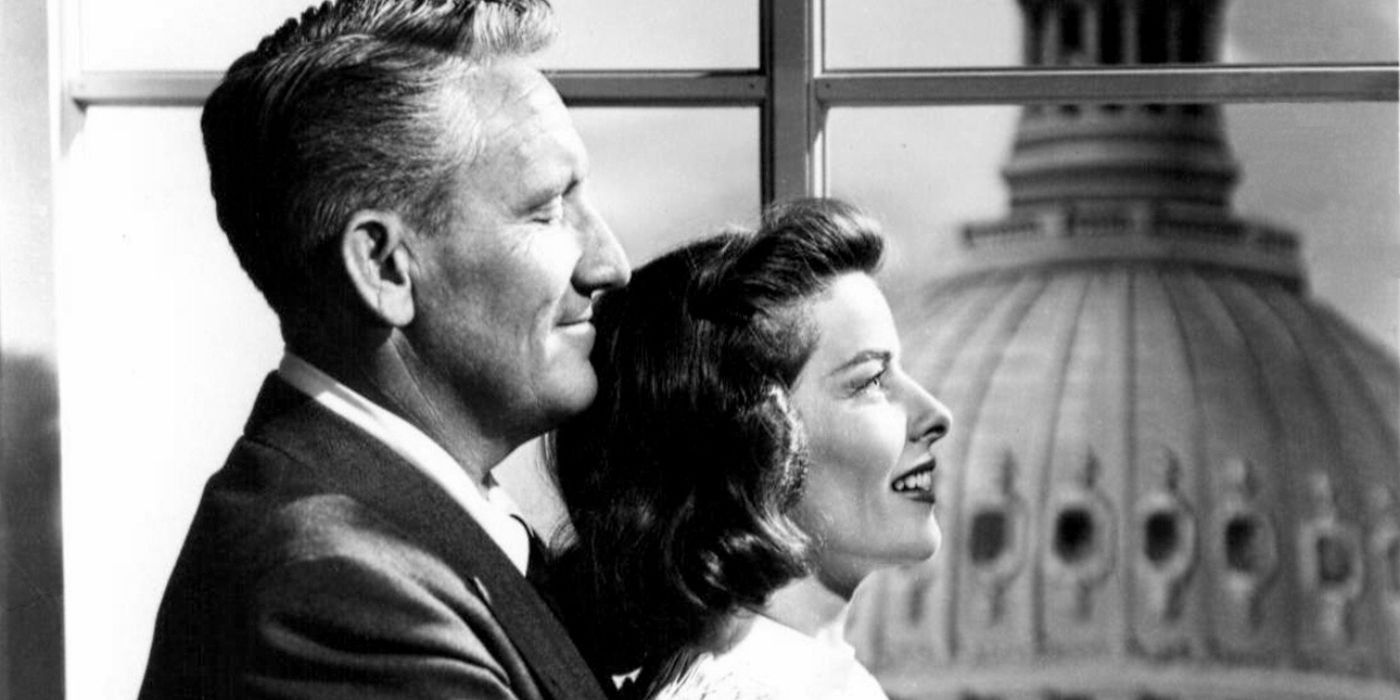 Spencer Tracy holding Katharine Hepburn with the White House in the background