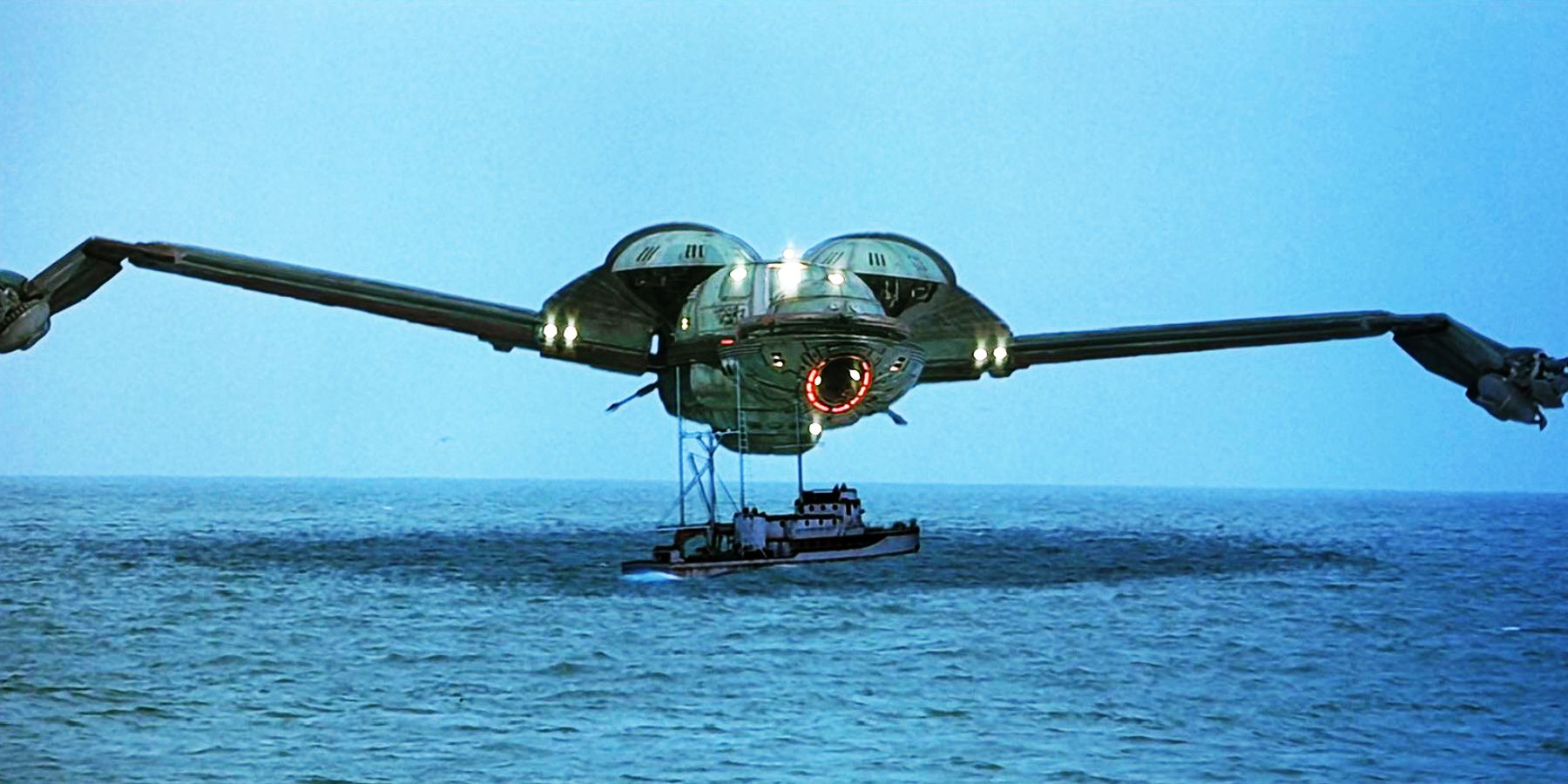 A space ship hovers ominously over a whaling boat