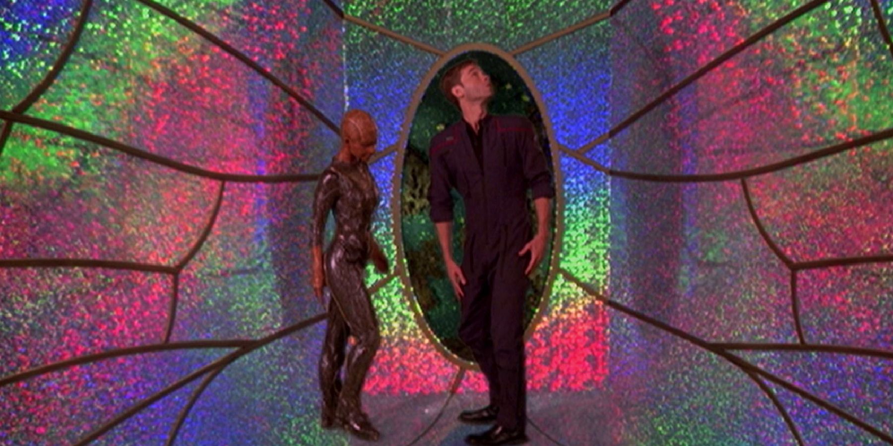 Trip examines a room decorated with reflective surfaces and webbing