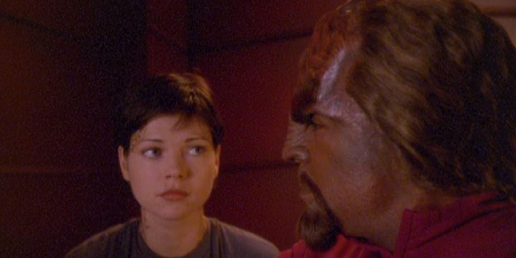 Nicole de Boer and Michael Dorn as Worf looking intensely at each other