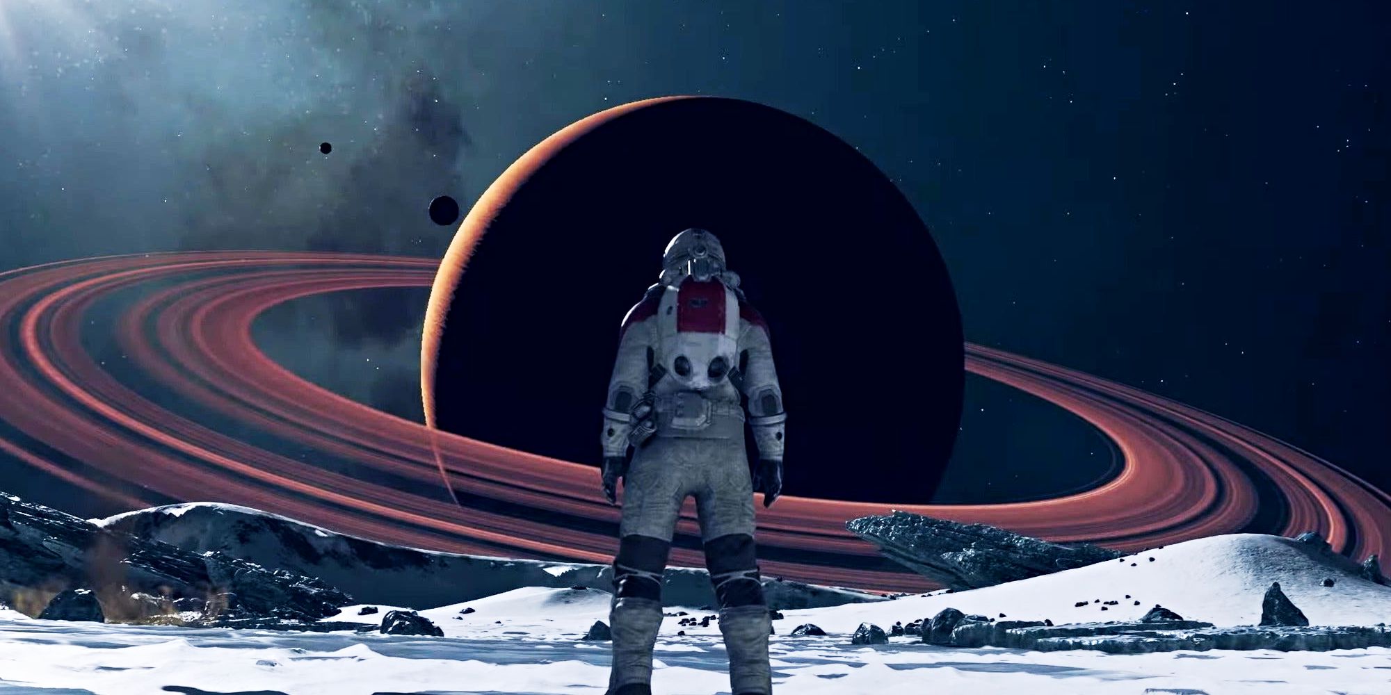 A Starfield character looks at a planet with rings around it.