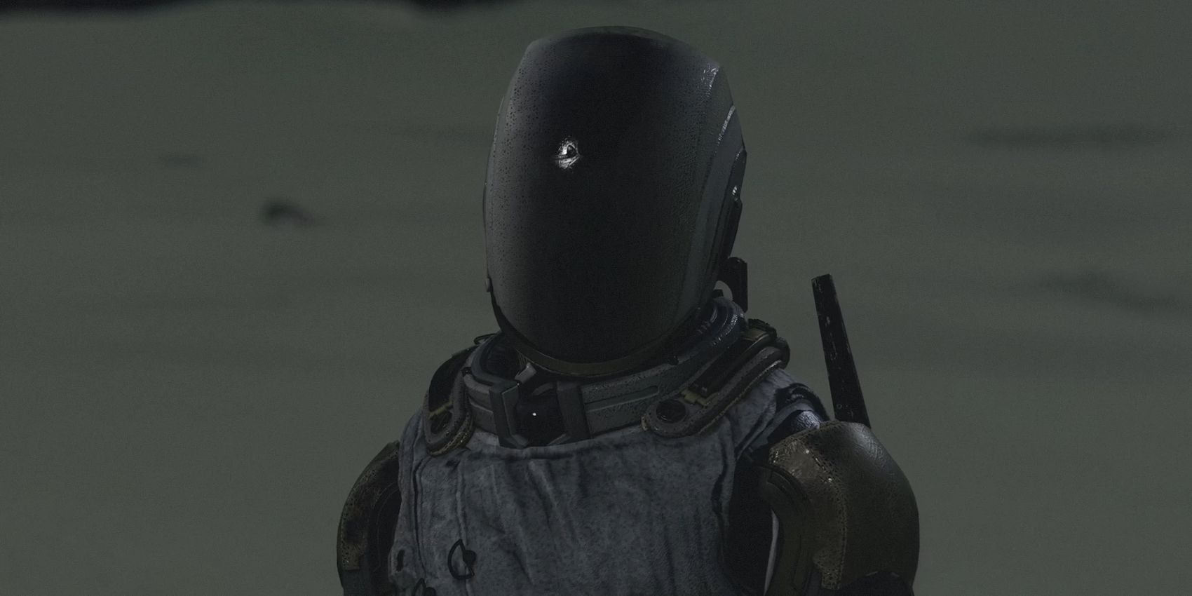 The Emissary stands on a darkened, sandy planet. Like the Hunter, they also wear a helmet that&rsquo;s so dark that none of their face is visible, but it&rsquo;s more round at the edges.