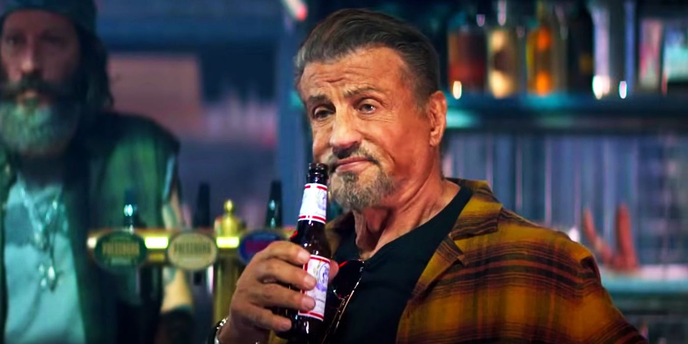 Sylvester Stallone drinking a beer as Barney Ross in The Expendables 4.