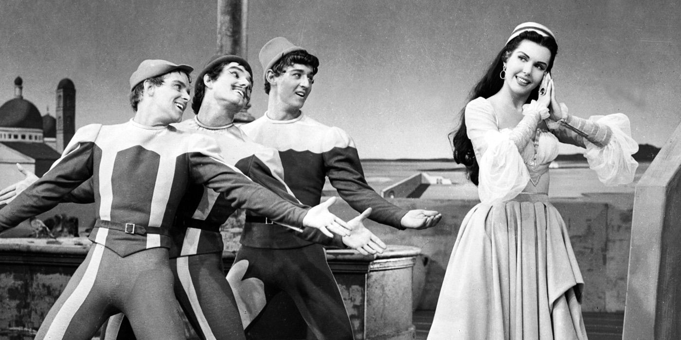 A woman swoons in front of three dancers in Kiss Me Kate