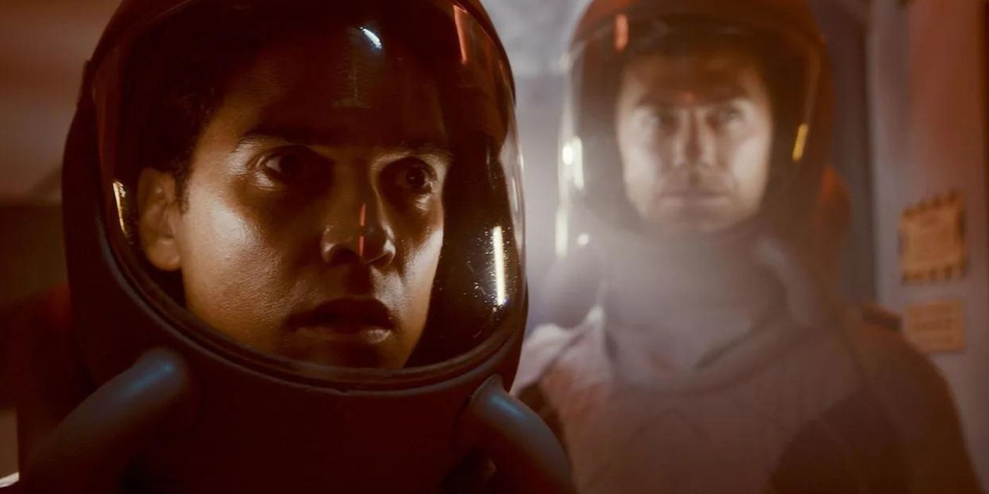 Sharon and Brice walk through a foggy corridor in space suits in The Ark