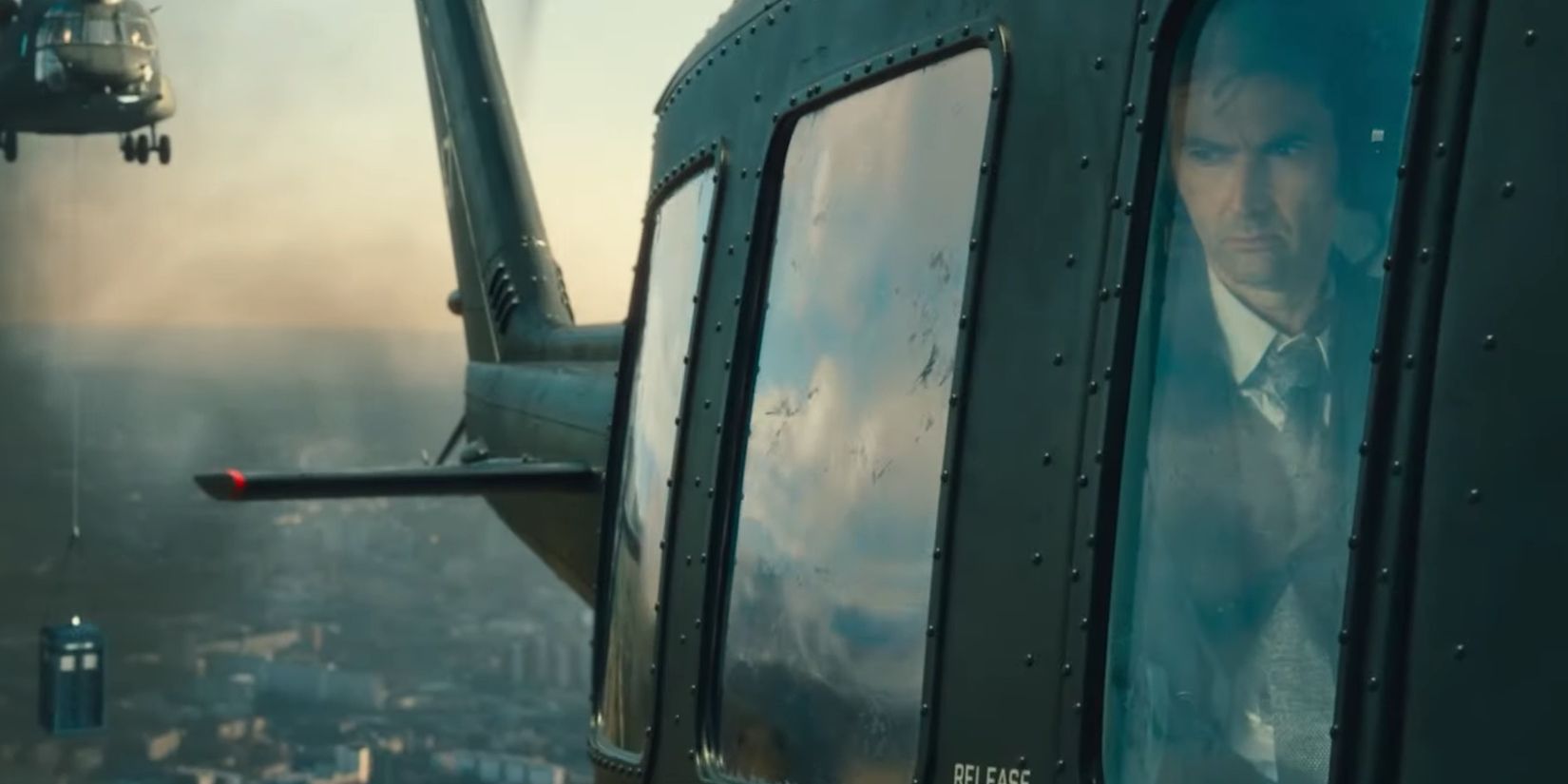 The Doctor in a Helicopter TARDIS being flown into UNIT HQ Doctor Who