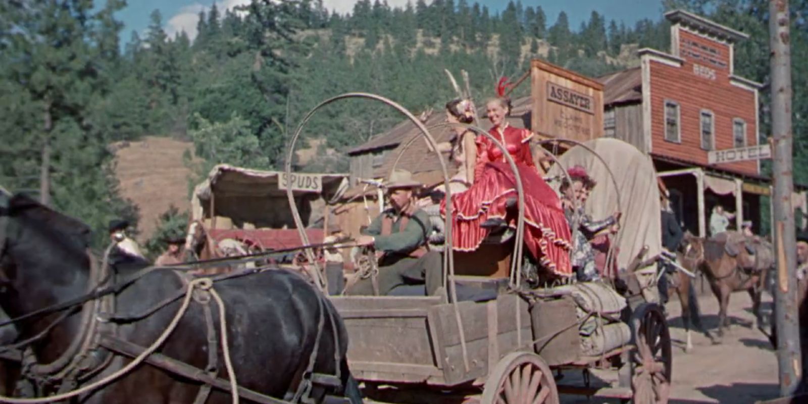 People ride through Skull Creek on a wagon.