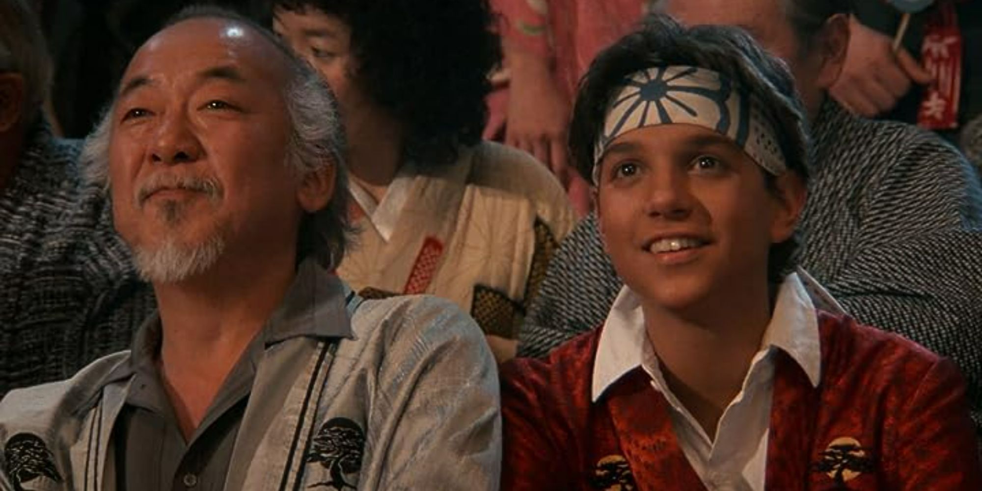 Mr. Miyagi (Pat Morito) and Daniel (Ralph Macchio) smiling in The Karate Kid