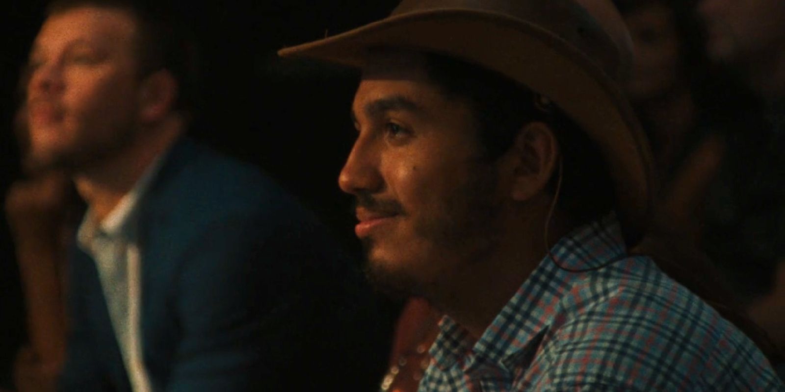 Tim sits in the audience smiling as he watches the play Joan, Still.