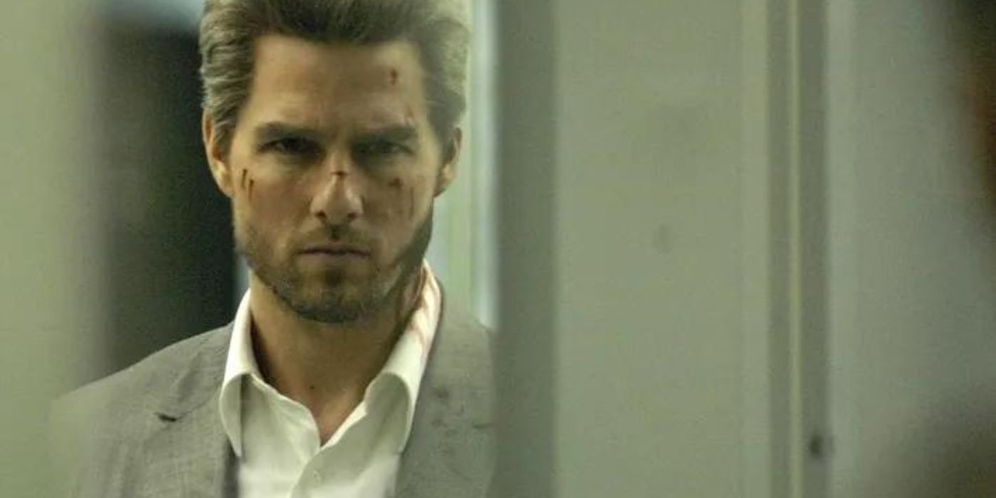 A scratched up Tom Cruise looking intensely in Collateral