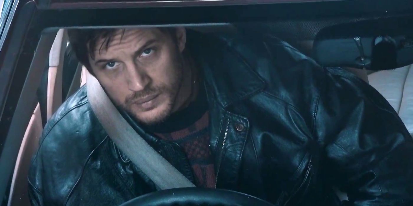 Tom Hardy sitting inside a car and looking upwards in London Road