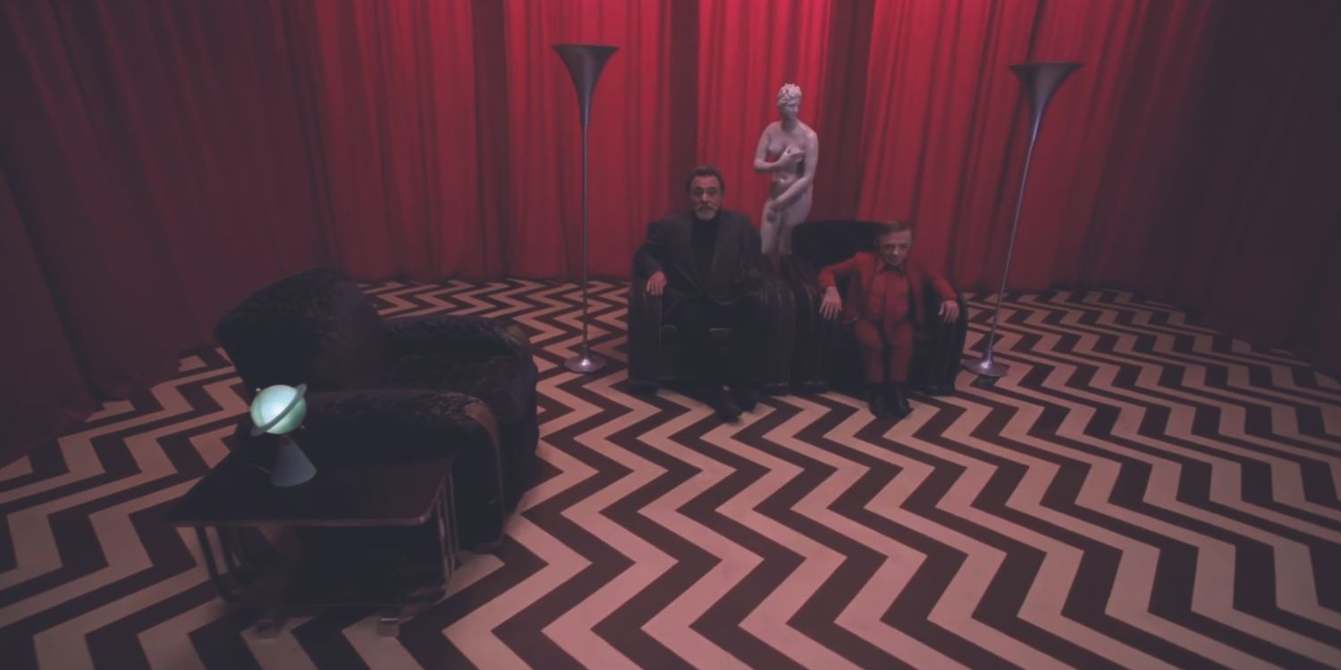 Two men sit on a couch in the Red Room in Twin Peaks Fire Walk With Me.