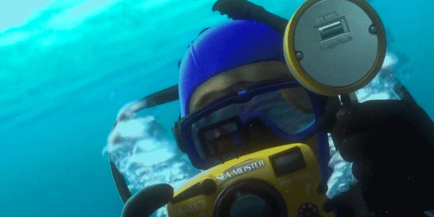 A scuba diver is holding up a yellow camera in Finding Nemo. 