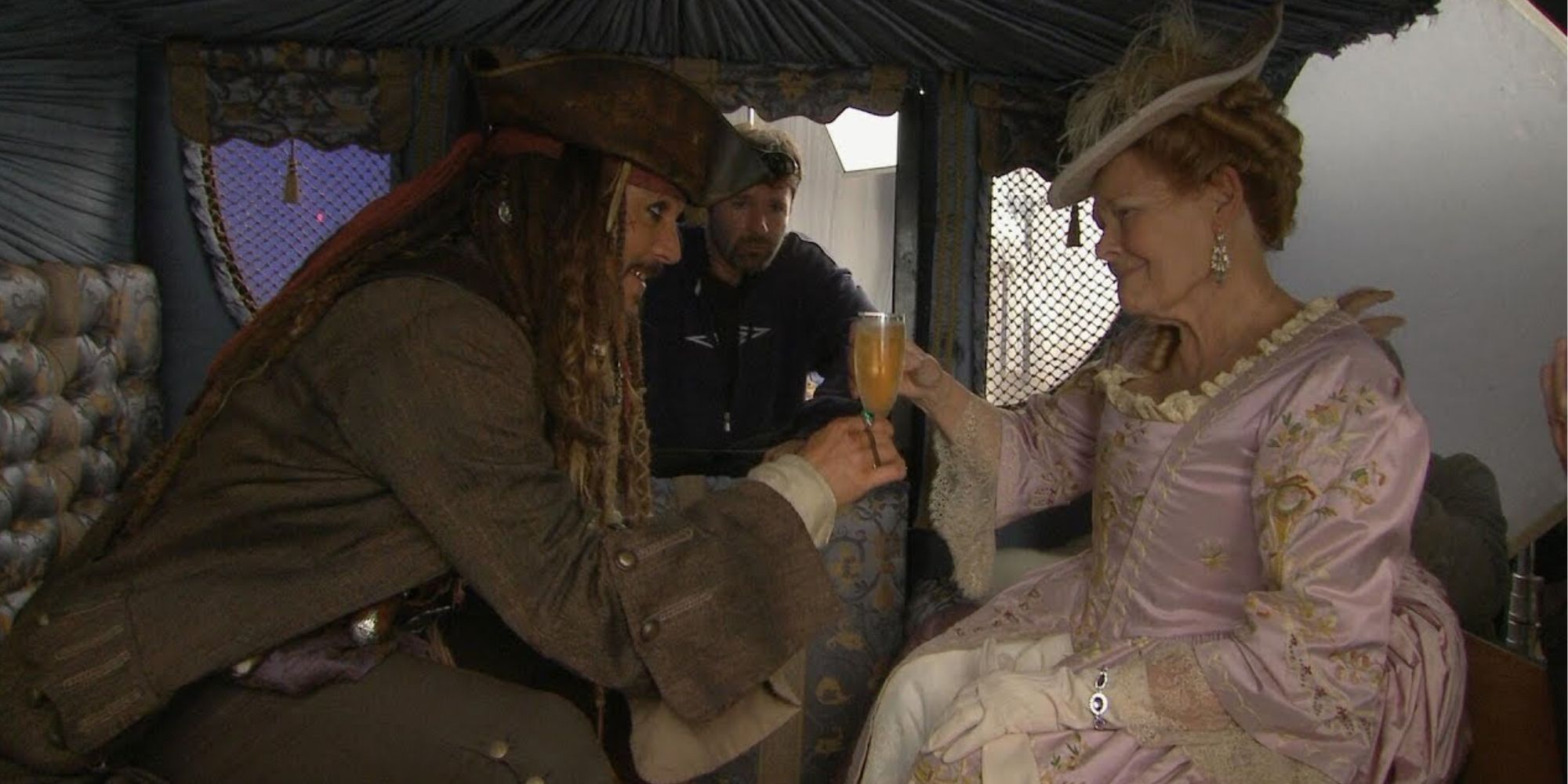 Judi Dench has a drink with Jack Sparrow.