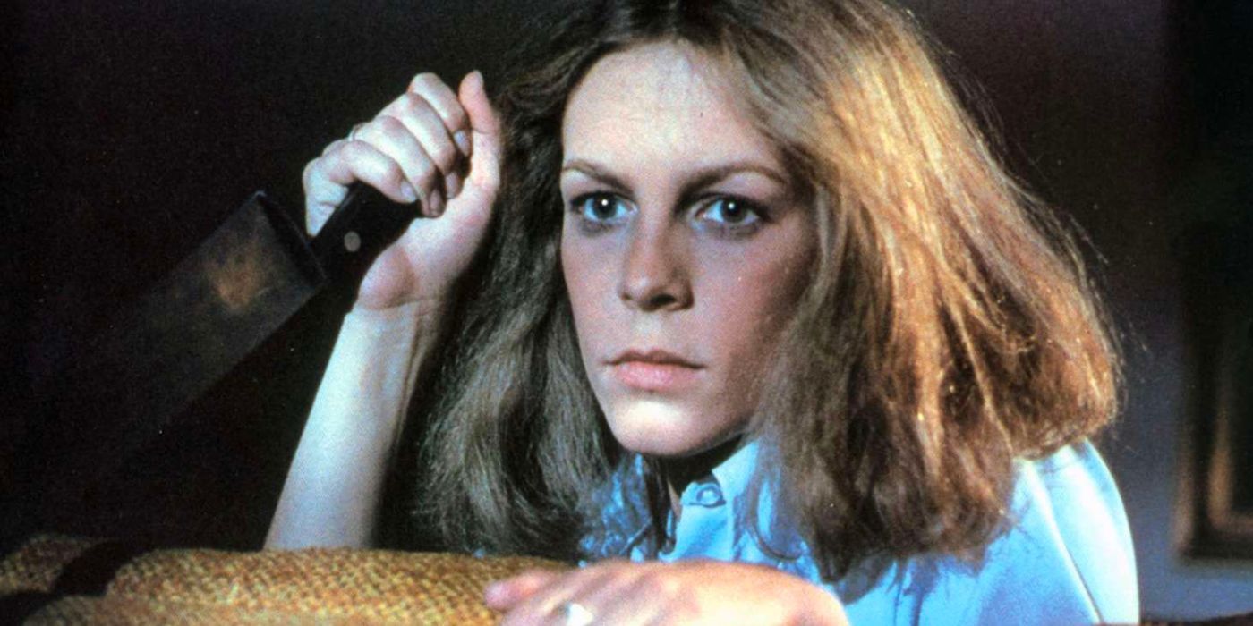 Jamie Lee Curtis holds up a knife in Halloween.