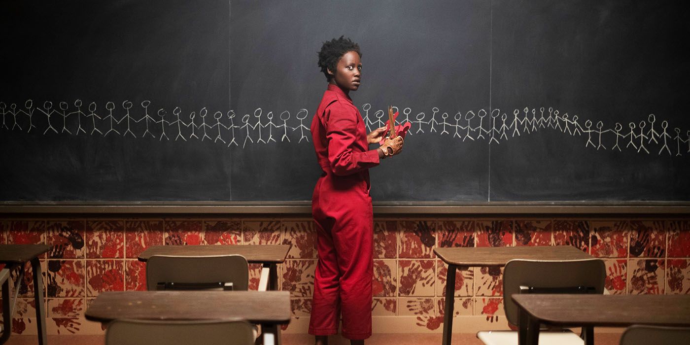 Lupita Nyong'o as Red by a chalkboard in Us