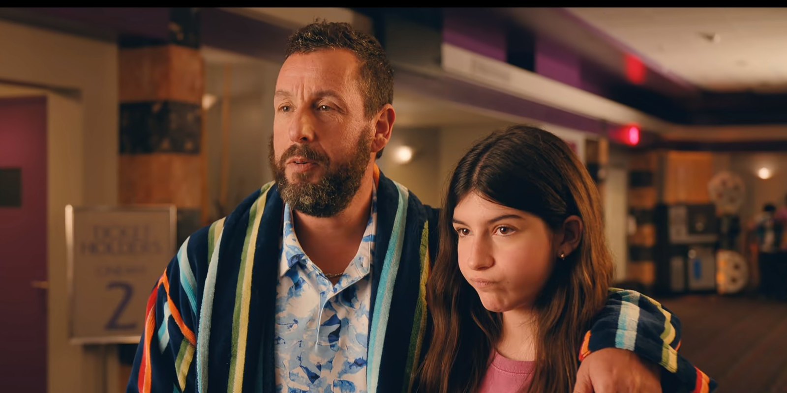 Adam Sandler with his arm around a frowning Sunny Sandler In You Are So Not Invited To My Bat Mitzvah