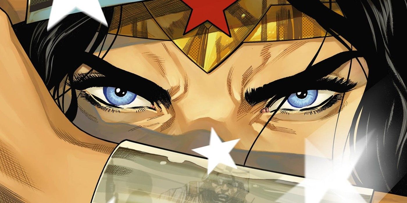 Close up of Wonder Woman, with a soldier reflected in her steel wrist gauntlet.