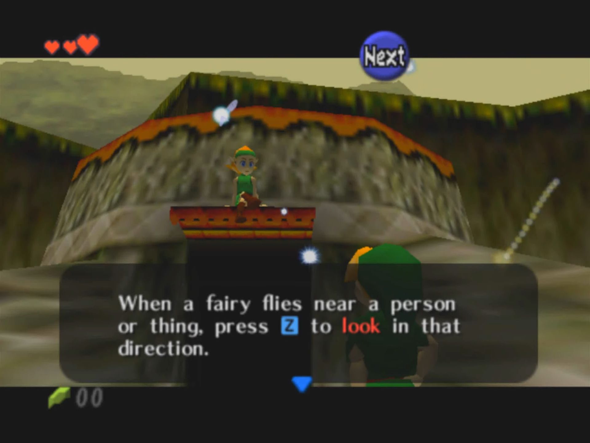 Link in Ocarina of Time looks up at a girl sitting on an awning above a door on a building that&rsquo;s been carved out of a giant tree stump. In a text box, the girl says, &ldquo;When a fairy flies near a person or thing, press Z to look in that direction.&quot;