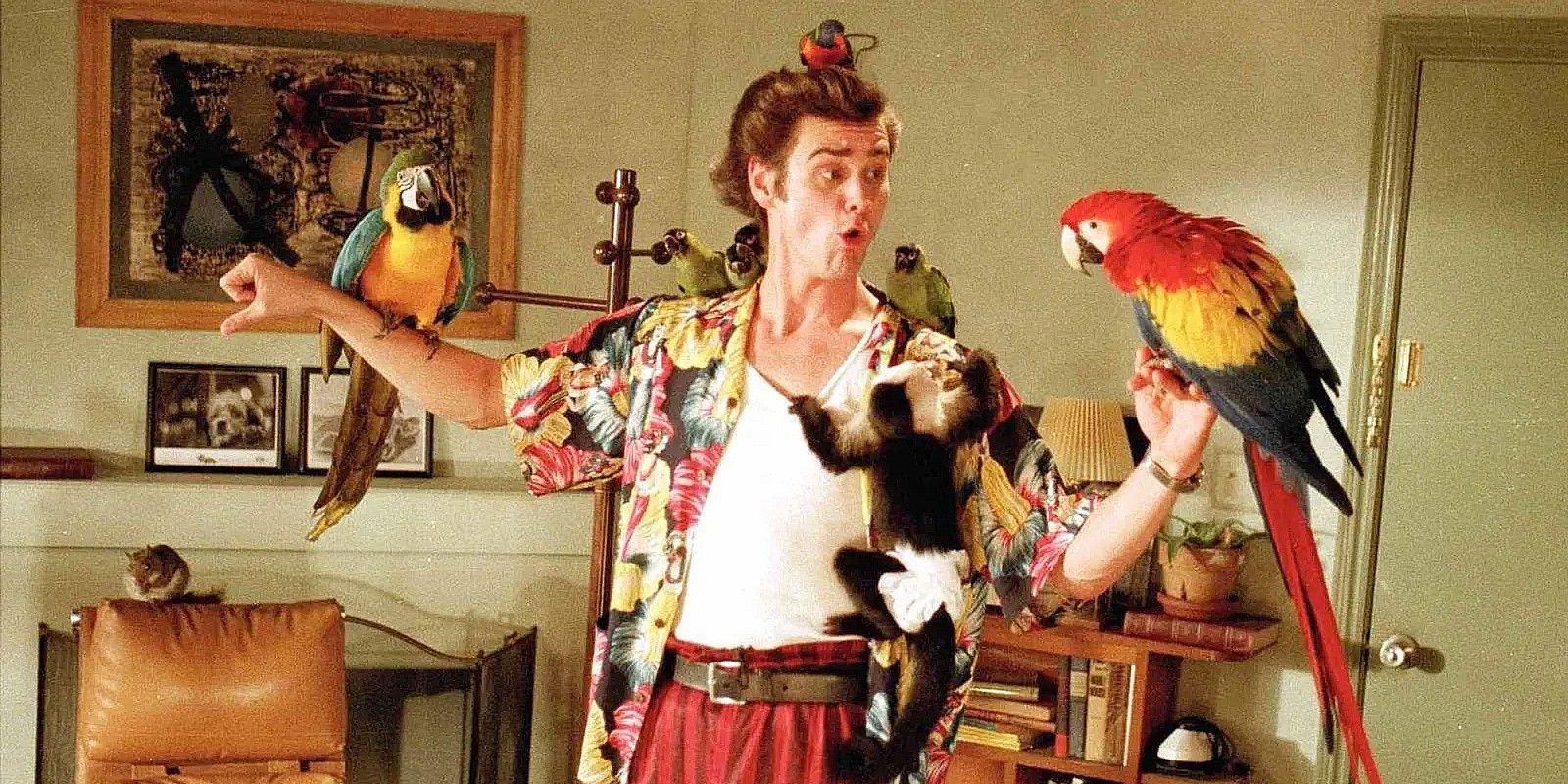 Ace (Jim Carrey) with various animals hanging off him in Ace Ventura: Pet Detective